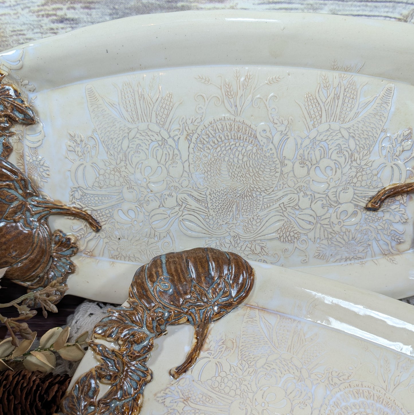 Decorative platter with embossed floral patterns and ornate handles.