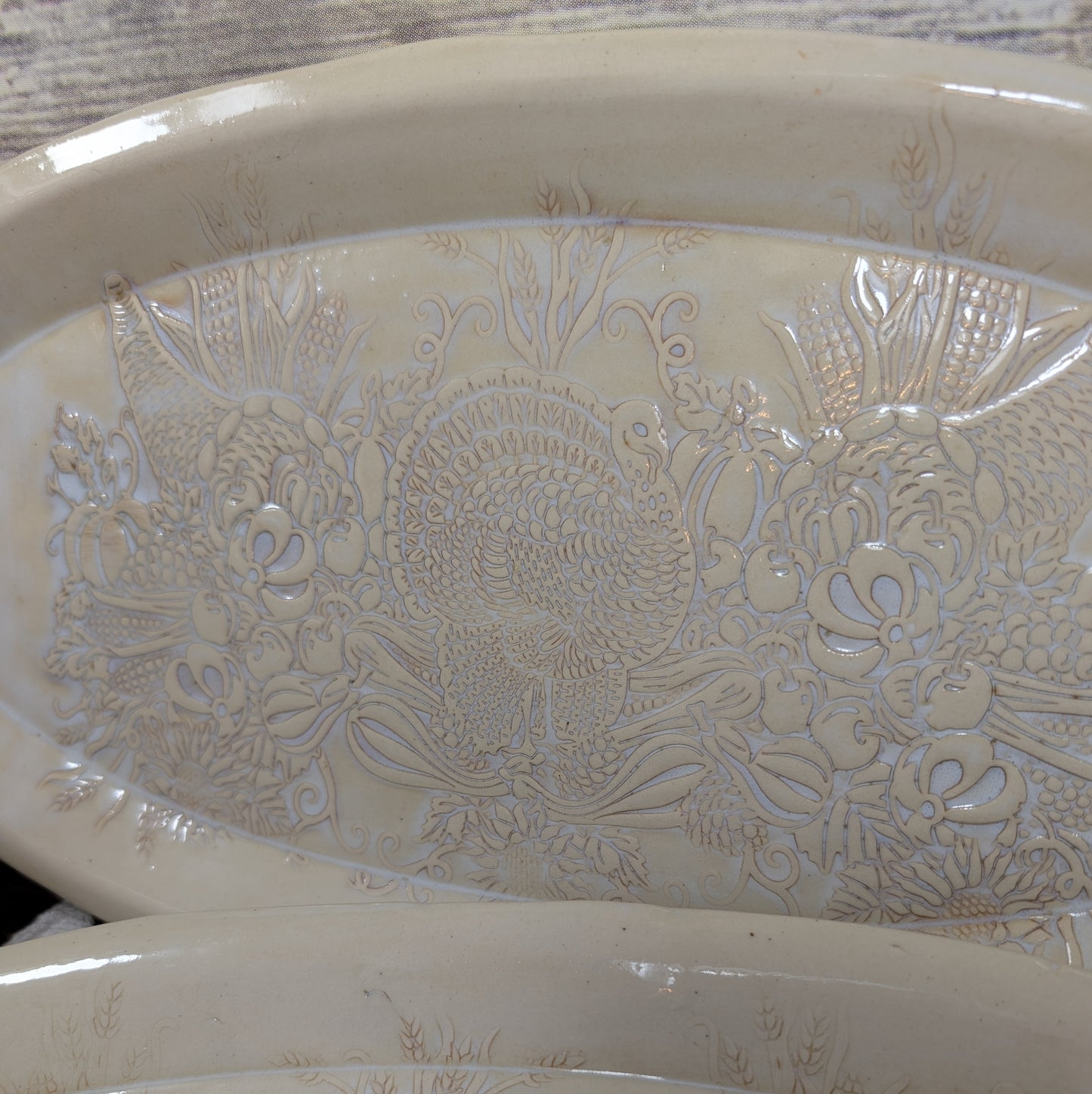 Decorative ceramic bowl with animal and food patterns on a wooden surface