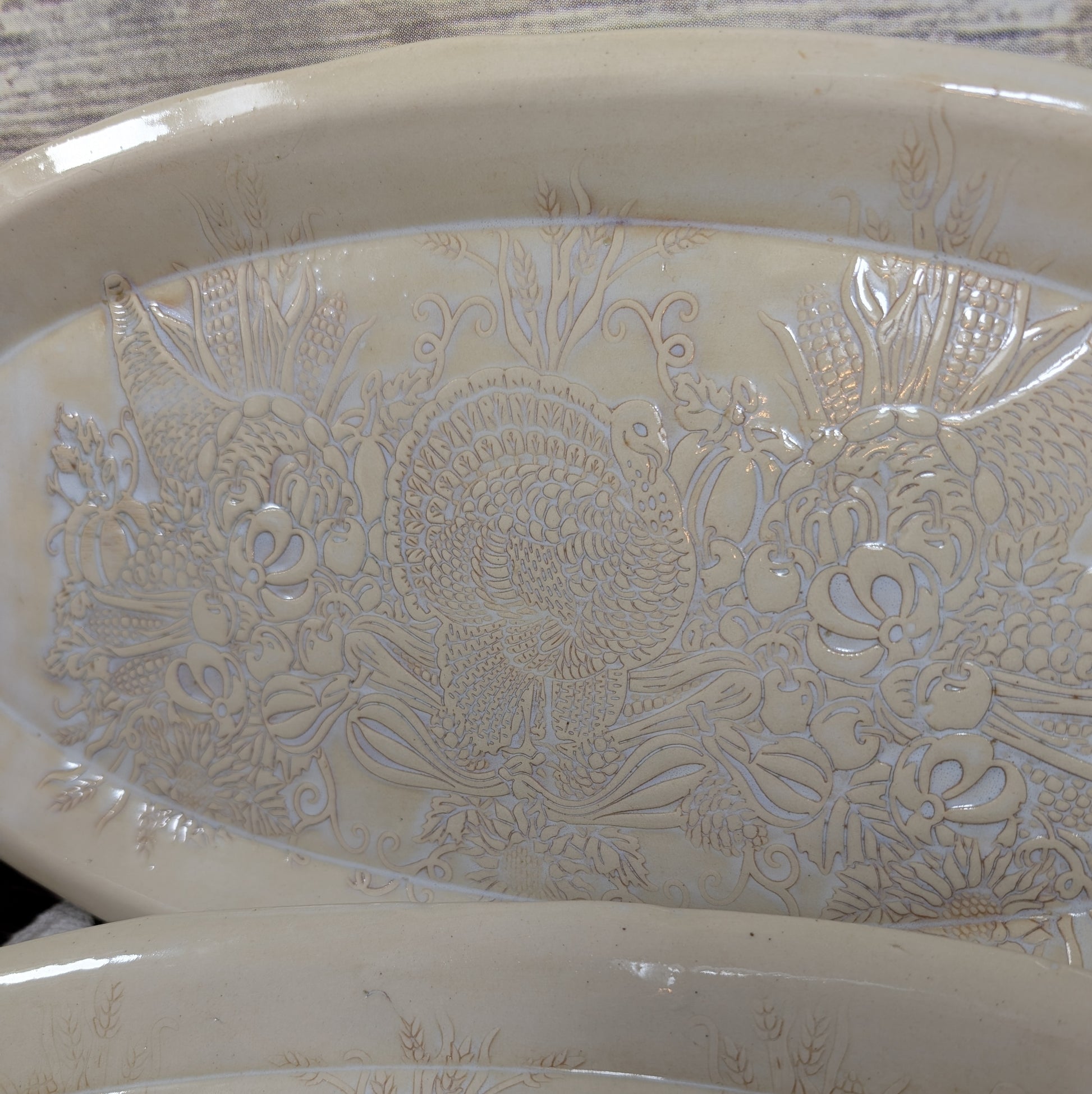 Decorative ceramic bowl with animal and food patterns on a wooden surface