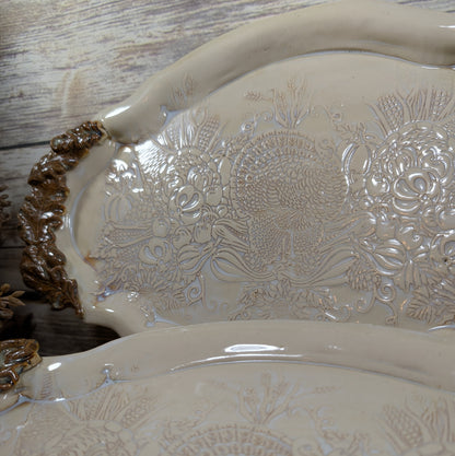 Decorative ceramic platter with floral patterns on a wooden surface