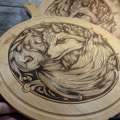 Wooden cutting board with engraved design of a fox