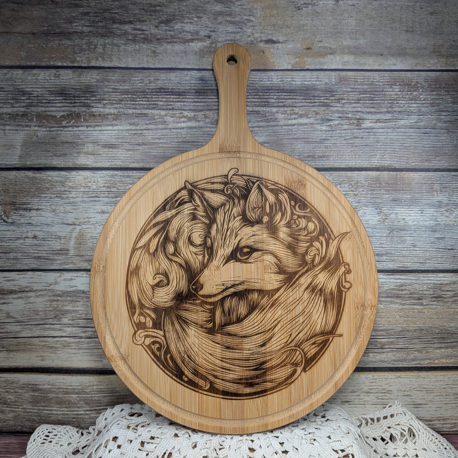 Wooden cutting board with engraved design of a fox on a wooden surface